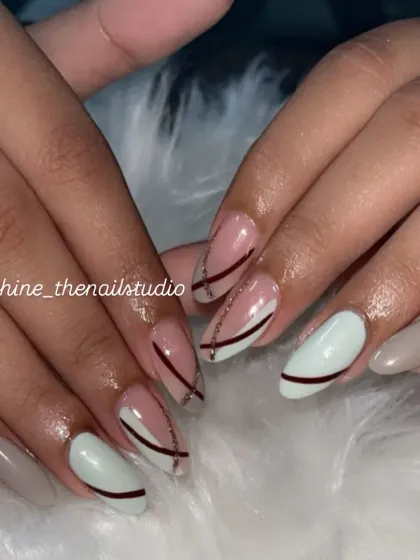 A modern, abstract design with a mix of white, grey, and pink nails with intersecting lines.