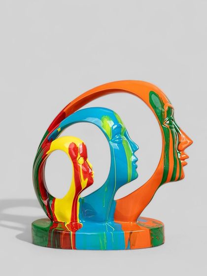 This abstract sculpture shows three faces nested within each other, each painted with bold, bright colors. It represents layers of personality and makes for a thought-provoking and visually engaging decor item.