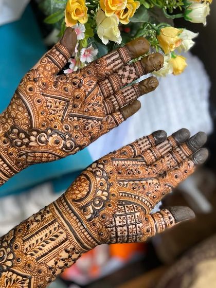 A close-up of the palms, highlighting the intricate finger details and the central patterns.