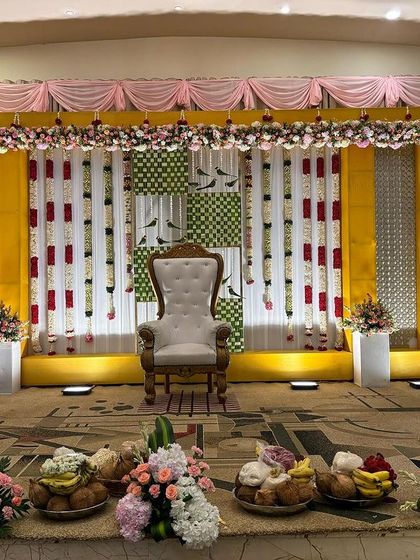 A simple stage with a yellow and green checkered backdrop, perfect for a puberty ceremony.