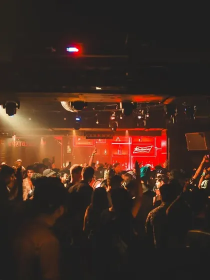 A wide shot of the dance floor at Kitty Su during the Innellea afterparty, showing a packed, energetic room.
