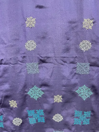 Another detail of the contemporary Kasuti saree, showing the precise, counted-thread stitches that form each individual motif.