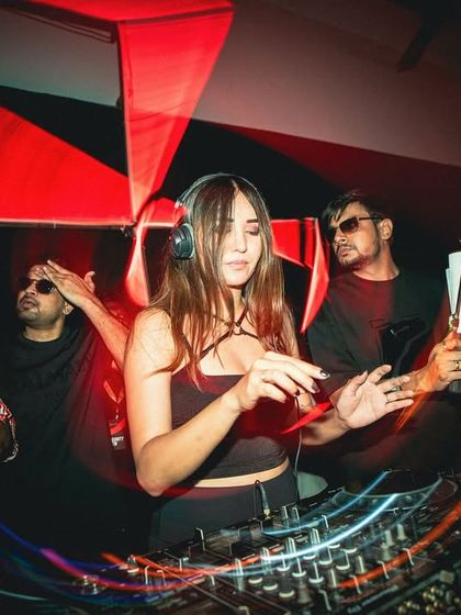 Lost in the music at a club in Nagpur. The red lighting and dynamic effects create an intense, immersive experience.