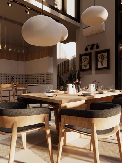 This open-plan dining and kitchen area is bathed in sunlight from double-height windows. I used a neutral color palette with black accents and natural wood tones to create a space that feels both modern and warm.