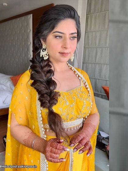 A classic side-swept fishtail braid, shown here without accessories for a clean, elegant look. This style is versatile and can be dressed up or down for any occasion.