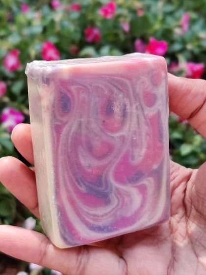 A classic drop swirl soap in shades of pink and purple. The way the colors blend together creates a soft, dreamy pattern that is unique to every bar.