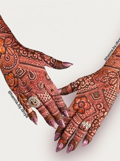 A full and intricate back-hand design. The mix of floral, paisley, and geometric patterns creates a rich texture that is perfect for a bride.