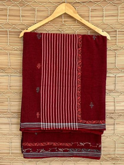 A rich maroon handloom saree from our Chikankari series. The combination of woven stripes and delicate embroidery makes this a timeless piece of wearable art.