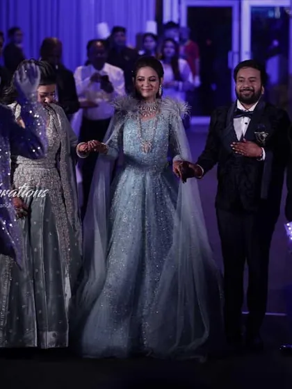 The couple makes their grand entrance, hand-in-hand, through a pathway of futuristic performers. This type of entry is perfect for a glamorous cocktail or sangeet night.