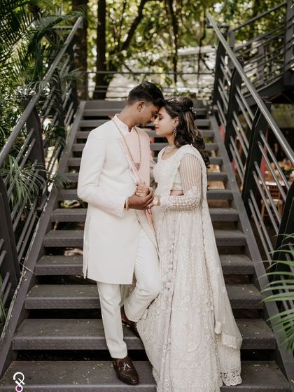 A romantic portrait of the couple on a staircase, capturing an intimate moment during their engagement shoot.