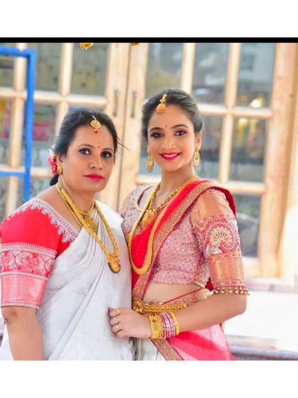 A client and her mother, both looking elegant. I designed the daughter's pink and white half-saree lehenga, focusing on delicate embroidery on the sleeves.