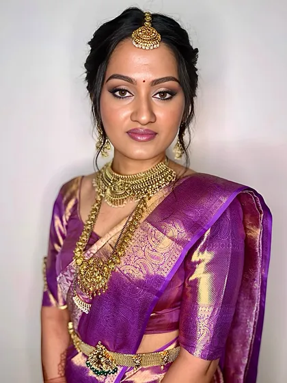 A direct, confident gaze from this stunning bride. The makeup is bold yet elegant, with expertly blended eyeshadow and a flawless base that looks like second skin.