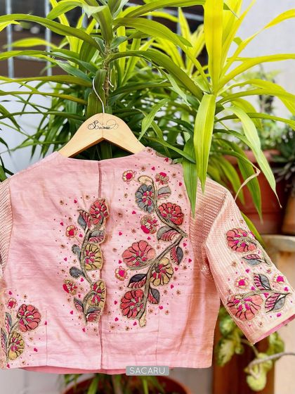 The back of the pink Kalamkari patchwork blouse, showing the beautiful floral embroidery climbing up the back panel.