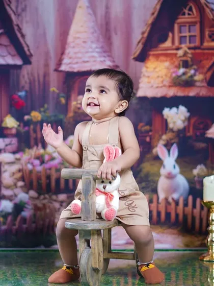 Looking up with a happy expression, this little girl is enjoying every moment of her themed shoot.