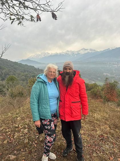 A photo with a student against the backdrop of the Himalayan range. These mountains are a constant source of inspiration and a reminder of the vastness of the universe.