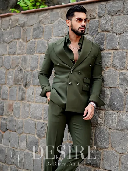 The olive green suit, styled with an open shirt for a more daring, modern look. This is for the man who makes his own rules.