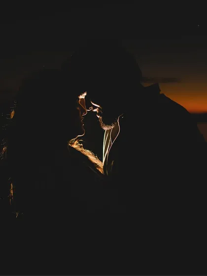A dramatic and intimate silhouette. I use creative lighting techniques like rim lighting to craft artistic and emotionally powerful images.