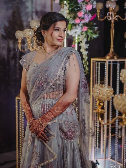 The bride in a beautiful grey lehenga, her dark henna stain providing a lovely contrast.