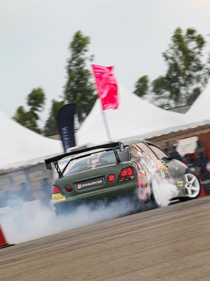 The rear view of the custom drift car, enveloped in a cloud of its own tire smoke. This is the art of drifting, a perfect blend of chaos and control.