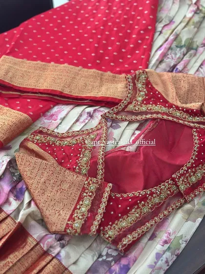 A complete set laid out, showing a red blouse with sheer, embroidered panels, paired with a red polka-dot saree and a floral skirt fabric.