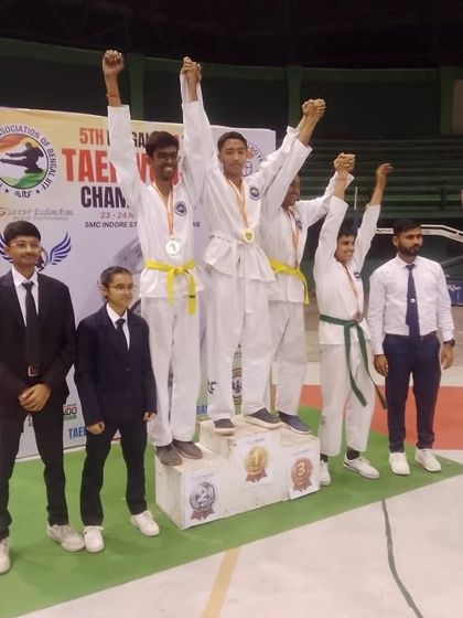 Young male athletes celebrating their success on the podium at the Bengal State Championship.