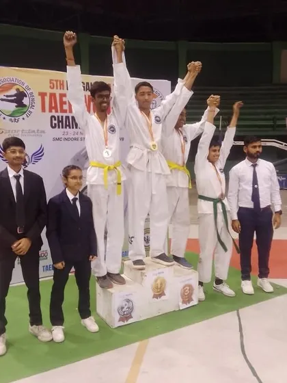 Young male athletes celebrating their success on the podium at the Bengal State Championship.