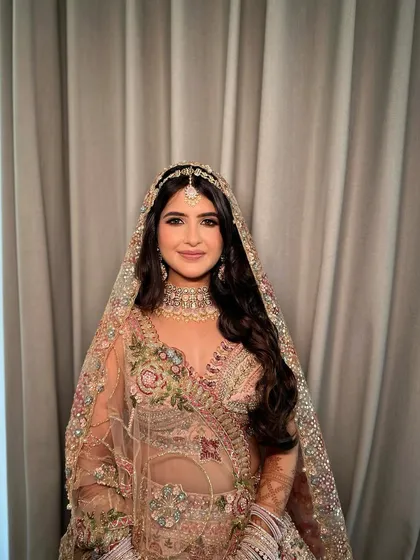 A frontal portrait of Ruchita, showcasing the symmetry and balance of her soft glam bridal makeup.