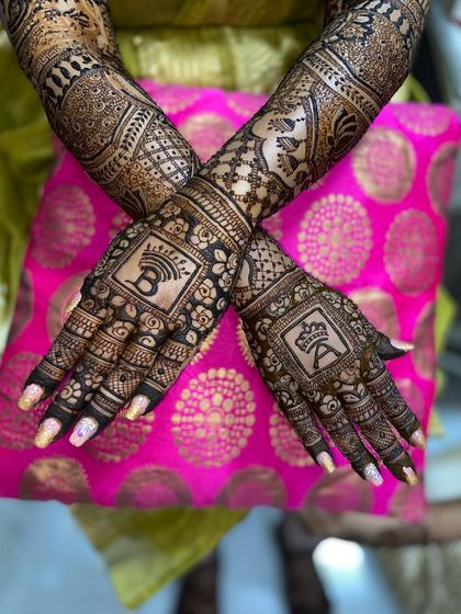 The same stylish design with the initials 'A' and 'B' with crowns, shown against a vibrant pink background.