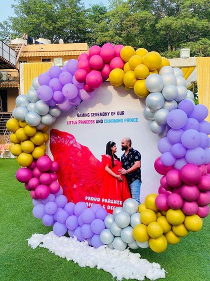 A full shot of the outdoor naming ceremony decoration, set up on a green lawn for a beautiful daytime event.