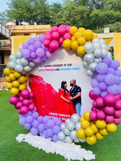 A full shot of the outdoor naming ceremony decoration, set up on a green lawn for a beautiful daytime event.