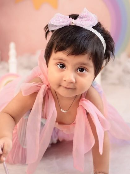 A close-up of this little fairy in her rainbow-themed wonderland. The soft pastel colors and dreamy props like her magic wand make for truly magical portraits.