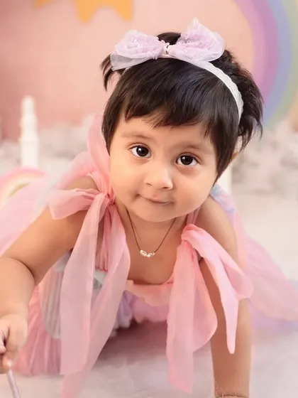 A close-up of this little fairy in her rainbow-themed wonderland. The soft pastel colors and dreamy props like her magic wand make for truly magical portraits.