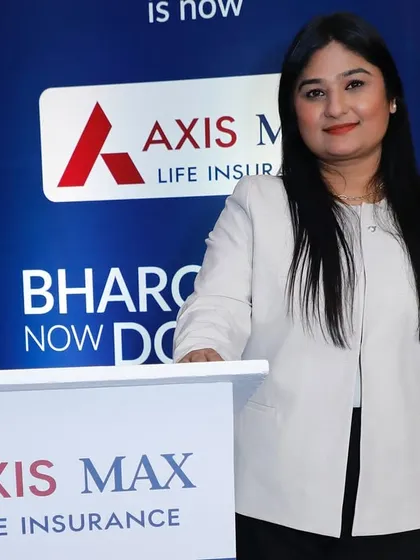 A professional portrait at the podium for the Axis Max Life event. I present a polished image for my corporate clients.