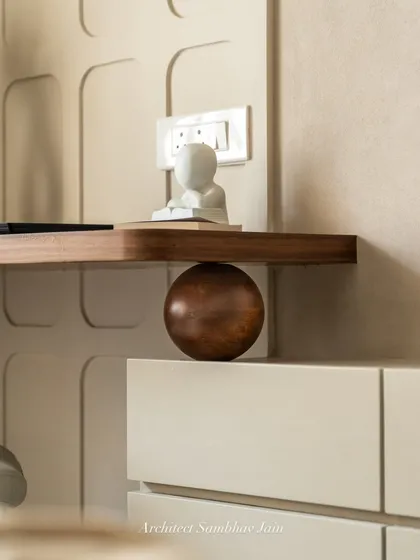 A play of geometry and balance, where warm wood tones meet muted PU finishes, anchored by a bold spherical detail. The floating shelf subtly defies convention, creating visual intrigue while maintaining functionality.