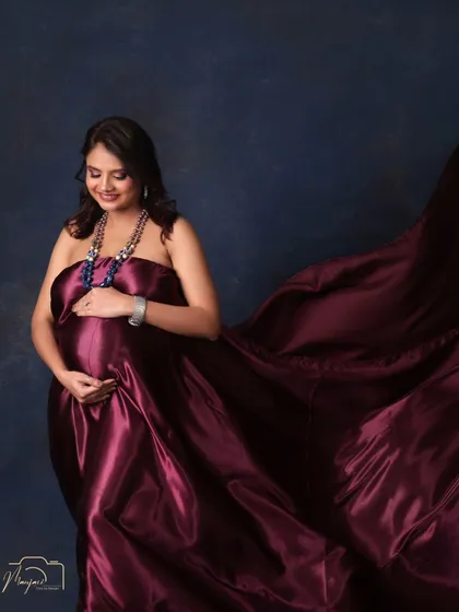A gentle and loving portrait. The way she cradles her bump shows the deep connection she already feels with her baby.