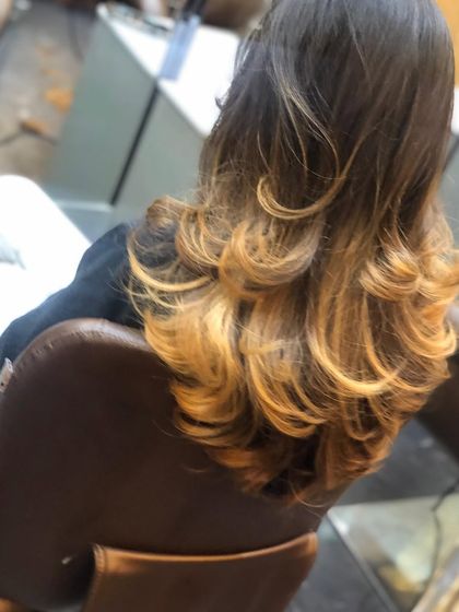 A back view of the golden ombre, showing the clear but well-blended transition of color. This is a popular and timeless style that adds a touch of glamour to any hair length.