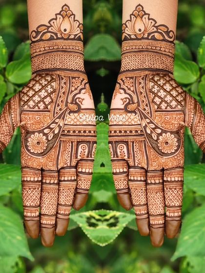 A symmetrical design with peacock and floral motifs, perfect for festivals like Teej.