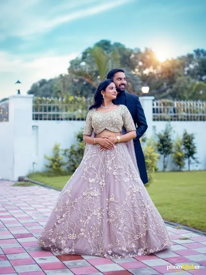 A classic engagement portrait of the couple in an outdoor setting, with the soft sunlight creating a beautiful, warm glow.