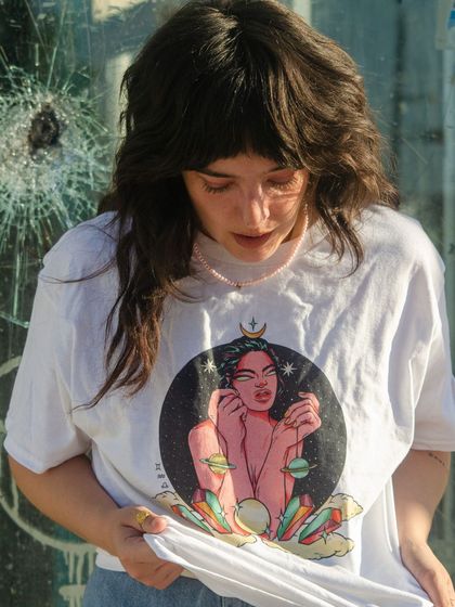 The 'Air' element T-shirt, featuring a celestial figure surrounded by planets.