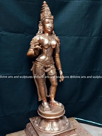 A bronze sculpture of Sivagami, a form of Goddess Parvati, crafted in the elegant Chola style. Her hand mudras (gestures) signify fearlessness and devotion.