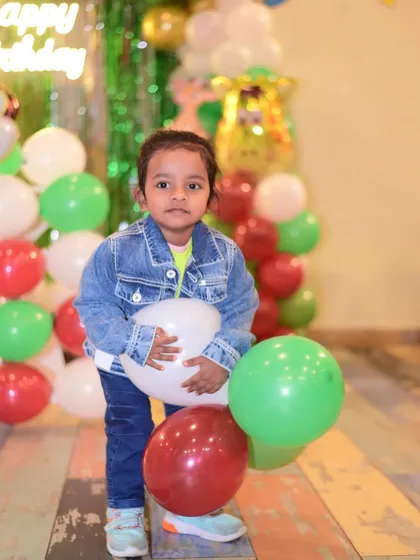 A candid shot of a young guest at a party. I aim to capture the natural joy and curiosity of children.