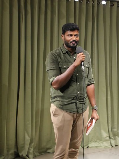 A performer takes the stage, ready to share their talent at our community meetup spot in Bengaluru.