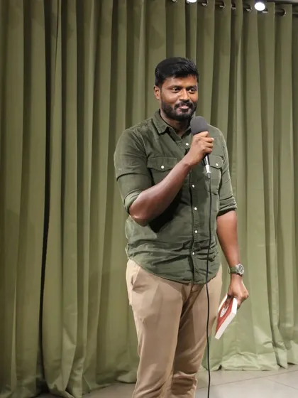 A performer takes the stage, ready to share their talent at our community meetup spot in Bengaluru.