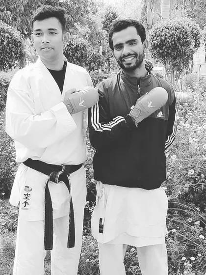 As a sensei, I train alongside my students. This picture shows me with a fellow karateka, ready for partner drills. I believe in leading by example through discipline and hard work.