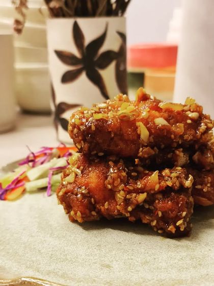 A close-up of food served on my handmade plate. The texture of the glaze beautifully complements the food, enhancing the entire dining experience.