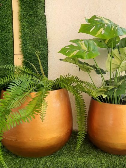 These large, rounded floor planters have a beautiful brushed copper finish. They are perfect for housing large artificial plants like ferns or monsteras and adding a warm metallic accent to your space.