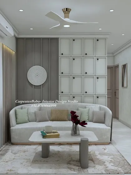 This living room uses wall paneling and a large abstract art piece to create a focal point. The curved sofa and simple coffee table complete the modern, comfortable look.