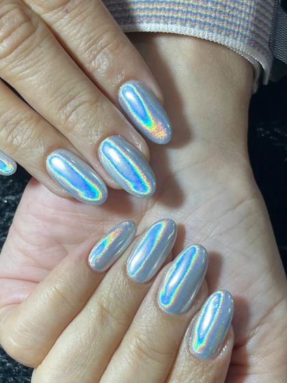 Another angle of the stunning silver holographic chrome extensions. The high-shine, mirror-like finish is perfectly smooth and incredibly eye-catching.