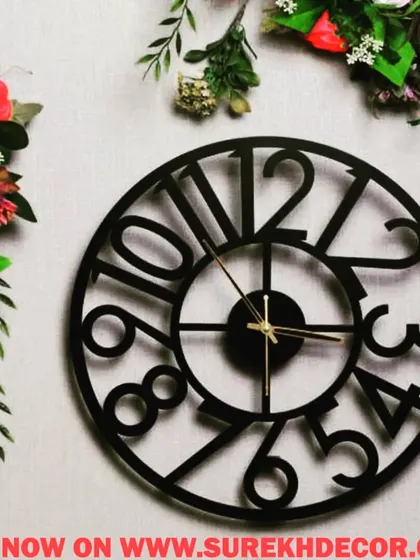 This modern wall clock features large, stylized numbers in a circular arrangement. The bold, easy-to-read design and simple black finish make it a great choice for a contemporary kitchen, office, or living room.