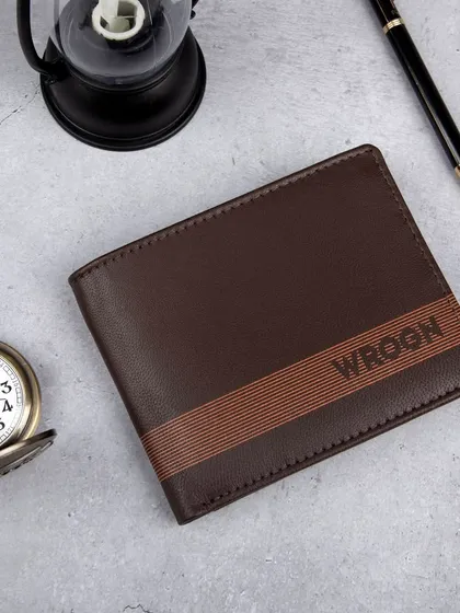 A styled flat-lay of a brown 'WROGN' wallet with a striped design.
